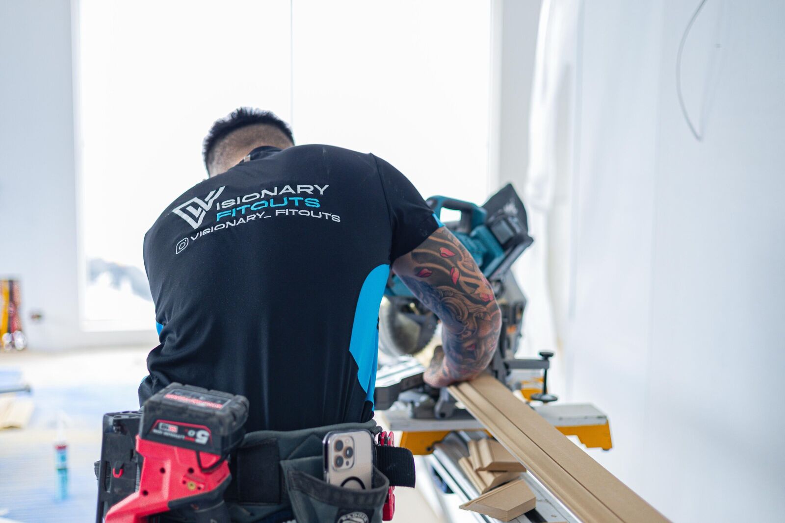 Visionary Fitouts carpenter cutting framing timber on a drop saw