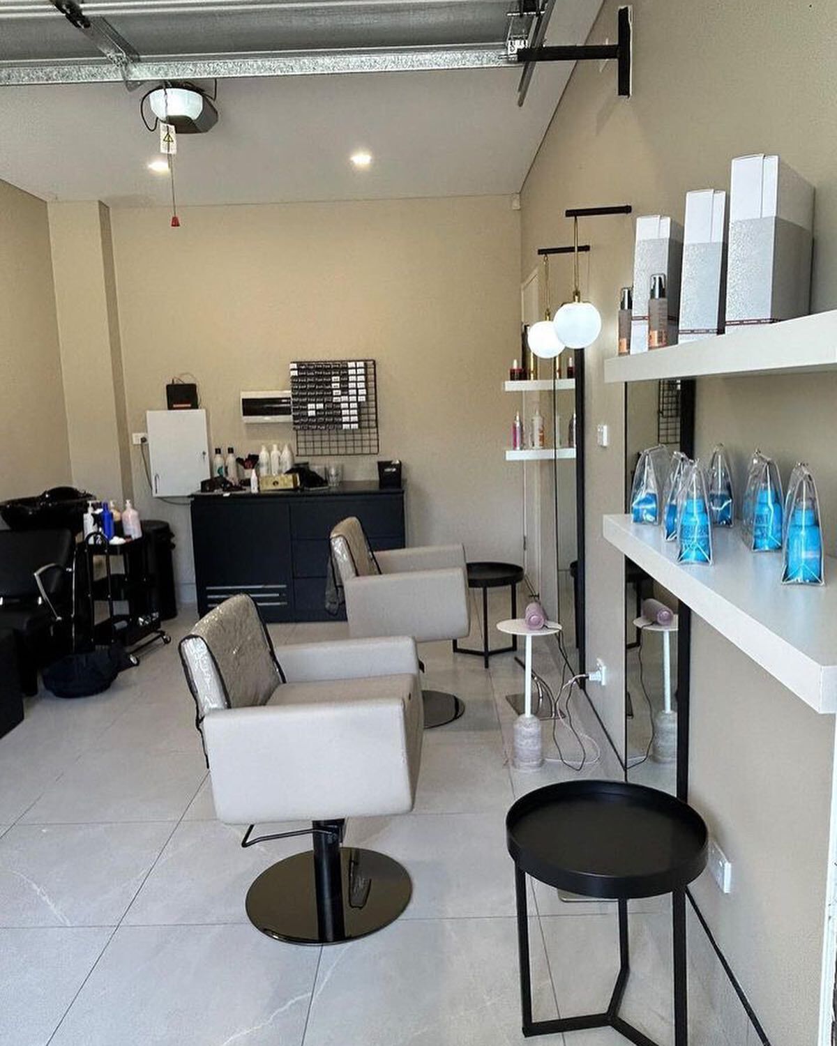 Retail fitout with white wall panelling and shelving