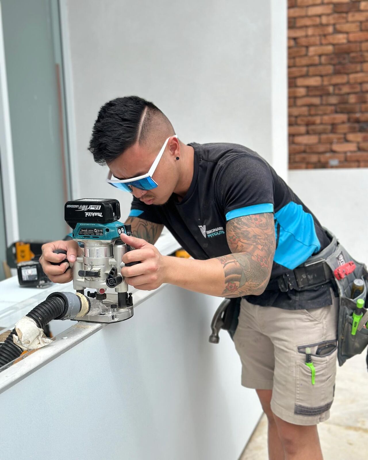 Visionary Fitouts carpenter routing a door for hardware